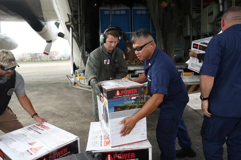 U.S. Coast Guard personnel help off-load relief supplies at the San Juan International Airport on Sept. 22, 2017. (Joe Raedle/Getty Images)